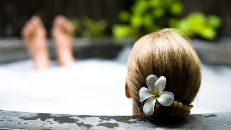 A woman enjoying the soothing benefits of hydrotherapy as she relaxes in a hot tub.