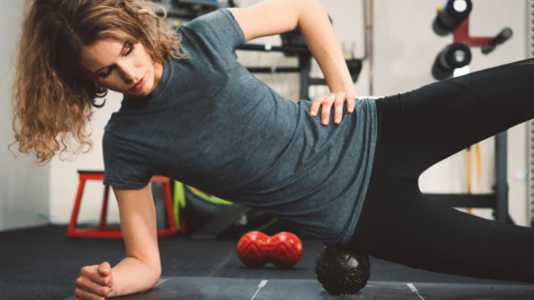 A young woman practicing Yoga Therapy Ball Exercises at a home gym.