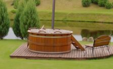 Cheddar hot tub positioned on a wooden base pad in an outdoor home garden