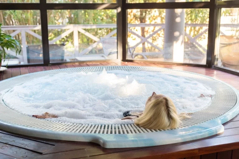 A woman enjoying in a 4 Season Inflatable Hot Tub with water bubbling