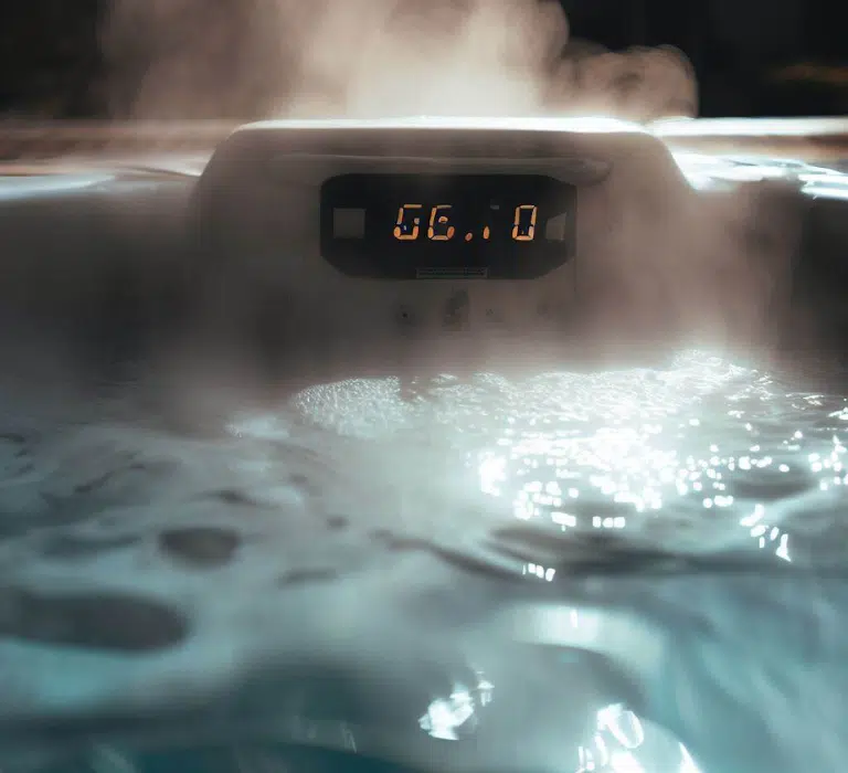 A luxurious hot tub with steam rising from the water, displaying the temperature on a digital panel.