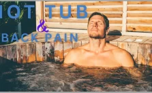 A man taking a hot tub bath while suffering from back pain.