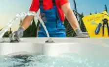 Skilled professional performing thorough hot tub maintenance