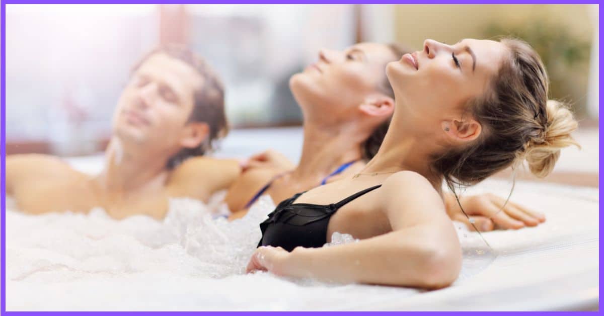 Three friends (one man and two women) enjoying a relaxing soak in a hot tub. (hot tub itchiness)