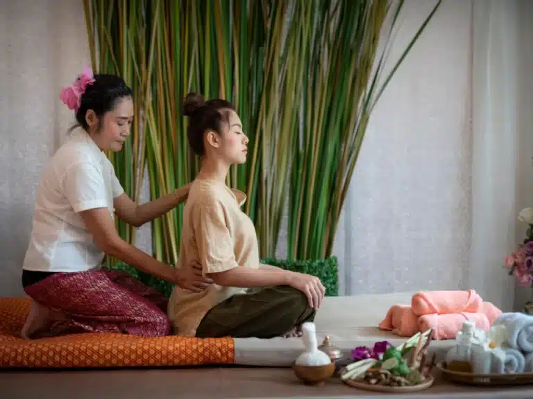 A skilled massage therapist performing a relaxing massage in a tranquil spa parlor