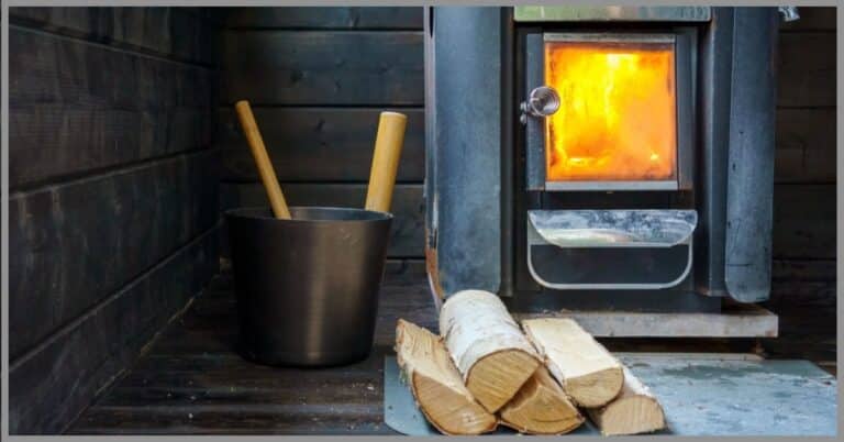 A sauna with a burning fire and extra wood placed nearby