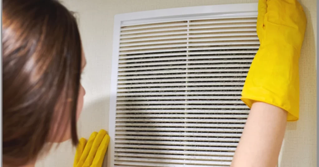 a woman cleaning ventilation for her sauna