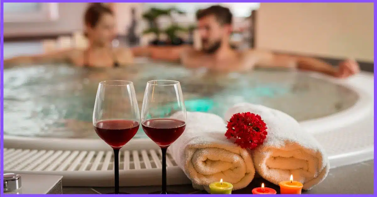 Two people in a hot tub with wine glasses and a city view. Their faces are blurred for privacy.