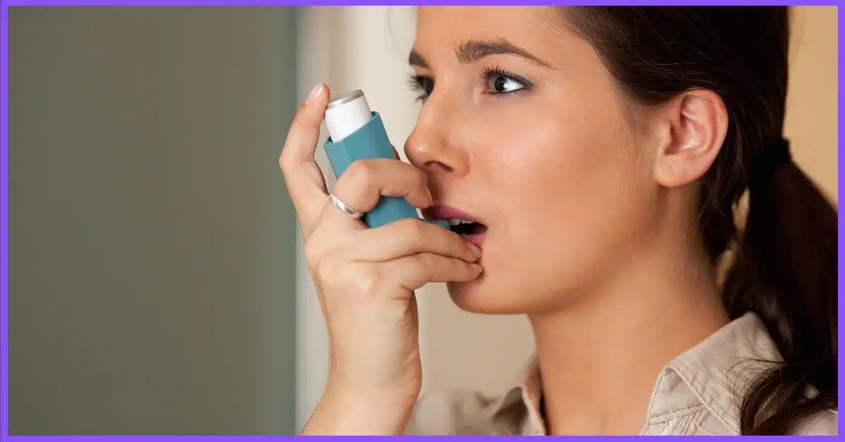 A young woman taking inhaler during her asthma (Hot Tub Benefits for Asthma Relief)