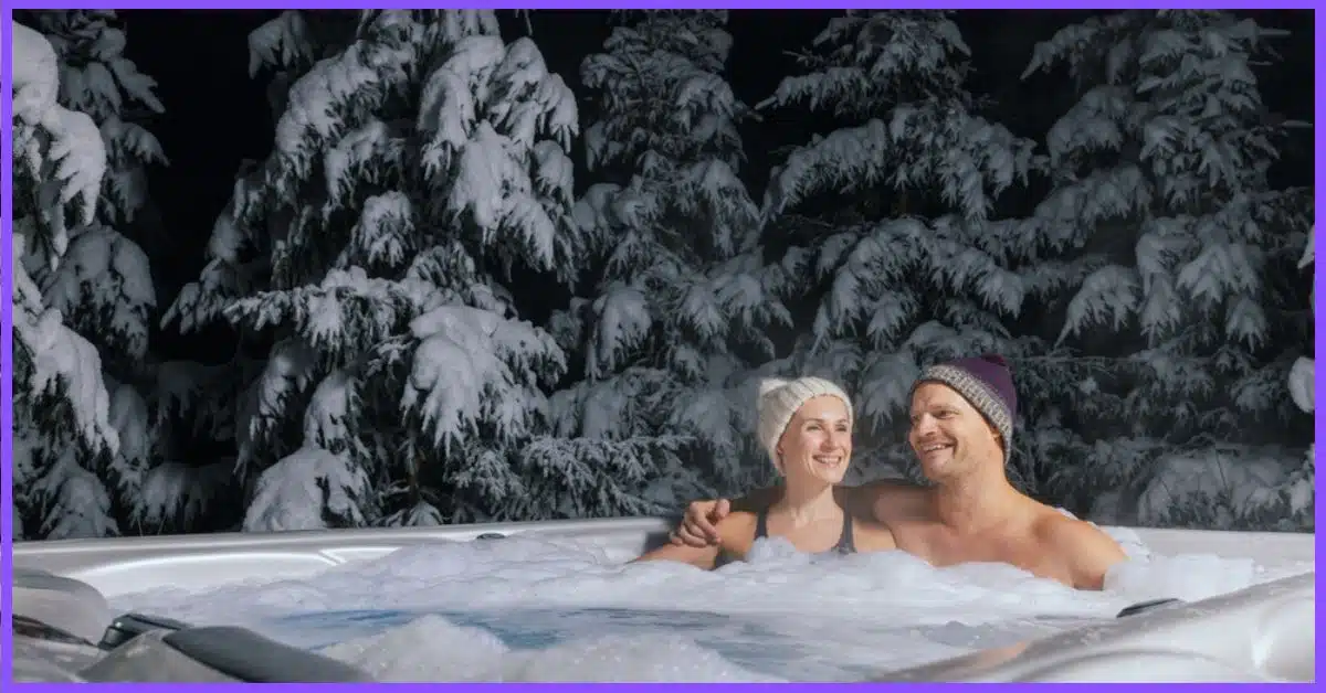 A hot tub in a snowy forest with a young couple in it at night. (What to Wear in a Hot Tub in Winter)