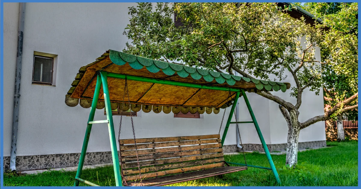 A 4 Seasonal Patio Swing with Canopy placed in a home garden.