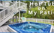 A hot tub placed in a home backyard with text info.