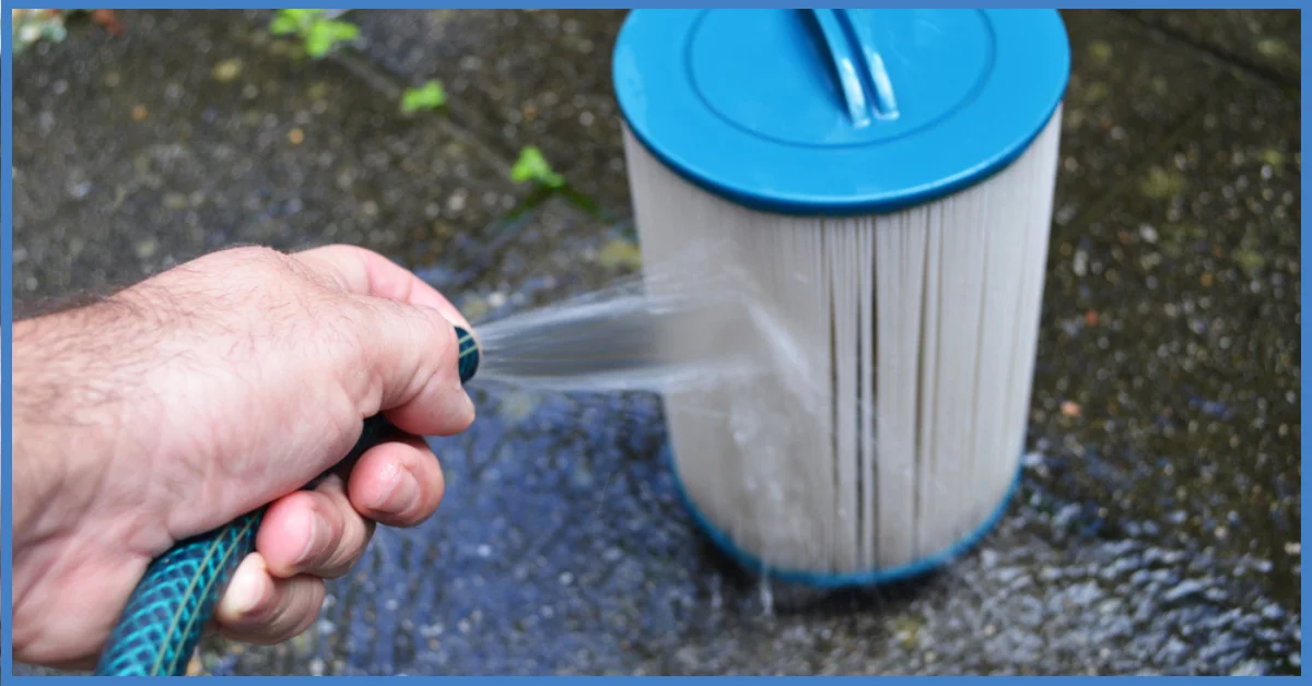 A man spraying water on a pool filter with a garden hose pipe. (How to Lower Alkalinity in a Hot Tub Naturally)