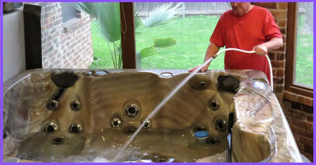 An elder man refilling a hot tub with a hose pipe. (refilling hot tub)