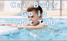 A baby enjoying in hot tub