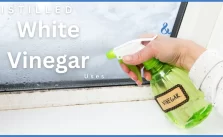 Man cleaning with Distilled White Vinegar using in a shower.