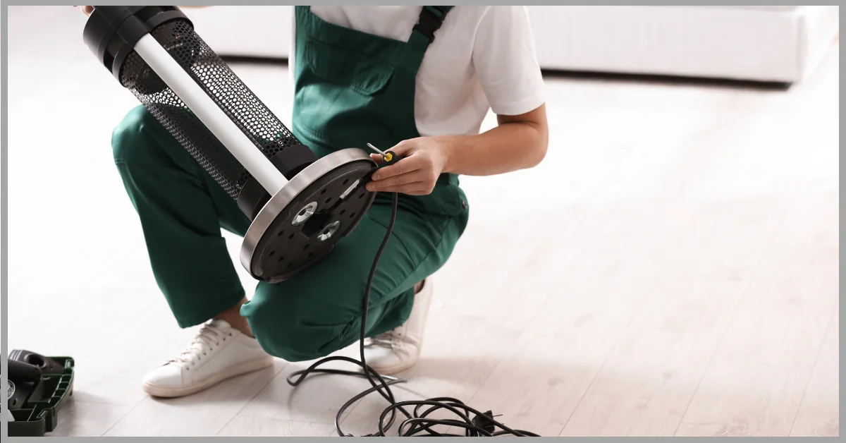 A person in green overalls and white shoes is holding a Fire Sense Patio Heater Thermocouple Replacement.