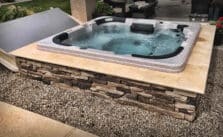 A inground hot tub on concrete deck