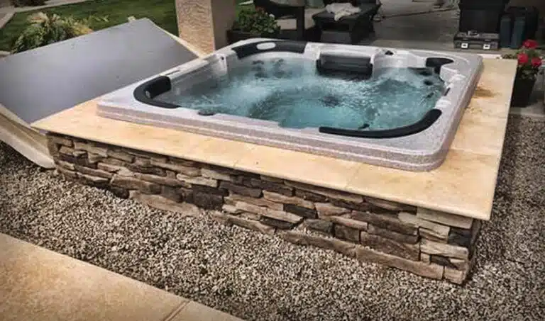 A inground hot tub on concrete deck