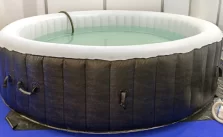 A Inflatable Hot Tub with full of water.