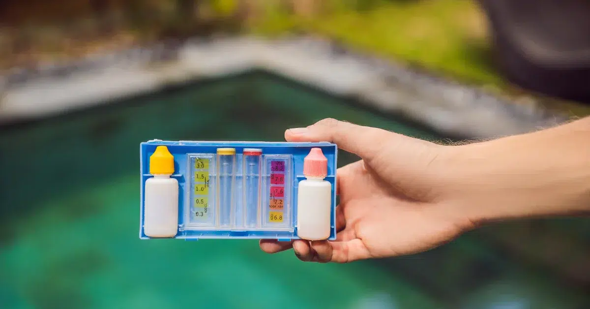 A man checking ph level with pool water alkalinity test strip