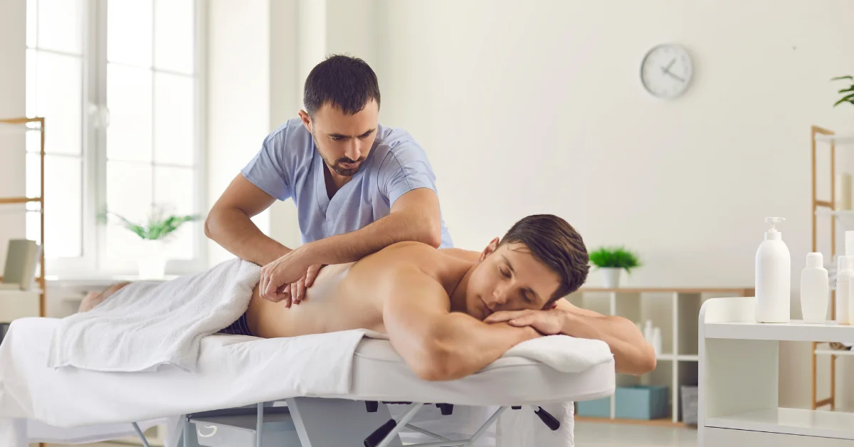 A person receiving a massage from a therapist in a bright therapy room. (Gay Massage for Stress Relief )