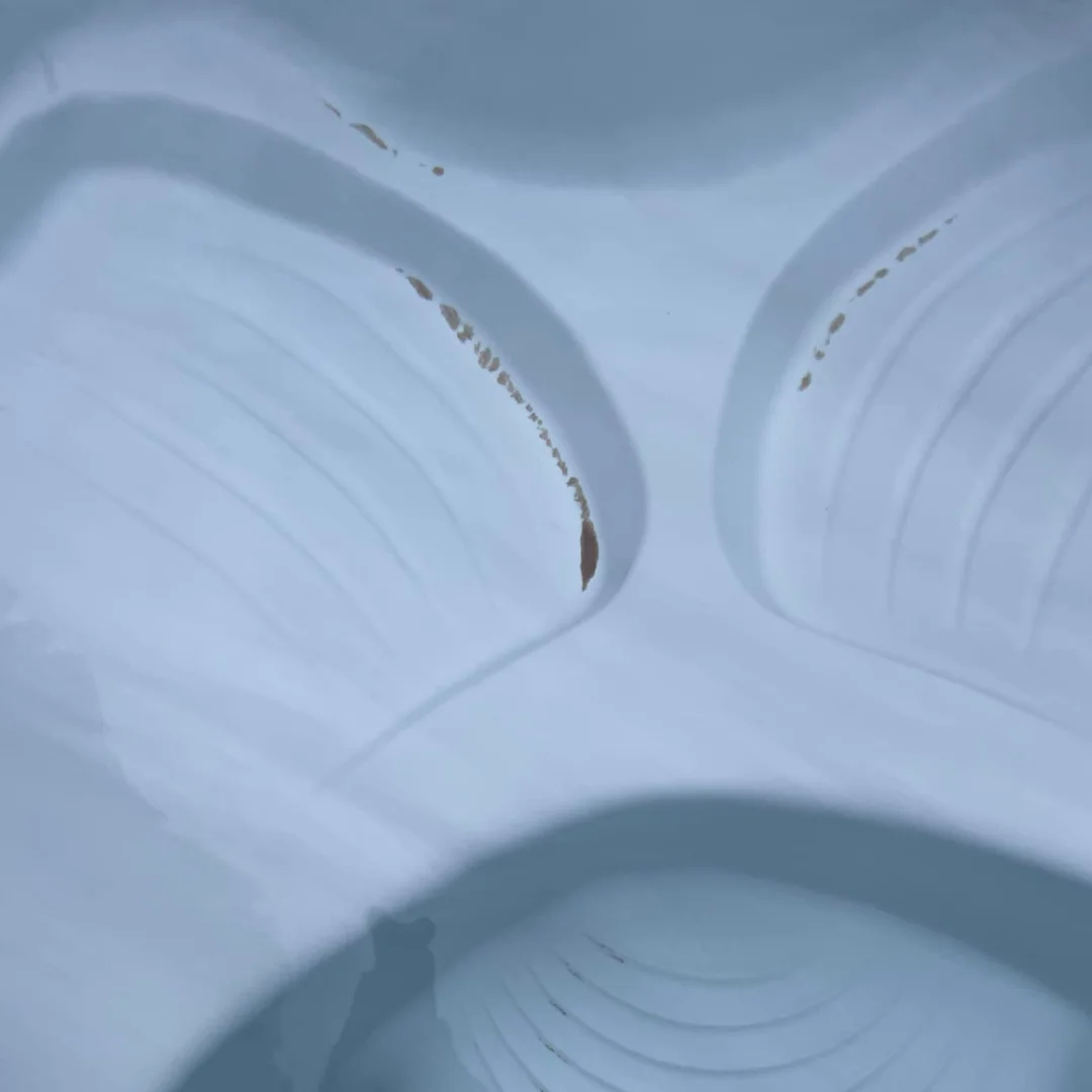 A hot tub with sand in bottom.