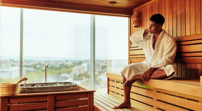 A man using Swedish Hotels wearing white robe.