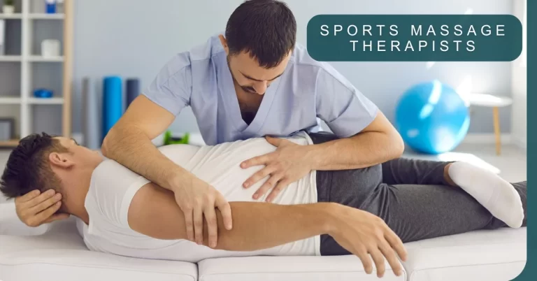 A sports massage therapist applying pressure to a client’s back. The client is lying face down on a massage table in a therapeutic or gym setting with exercise balls in the background.