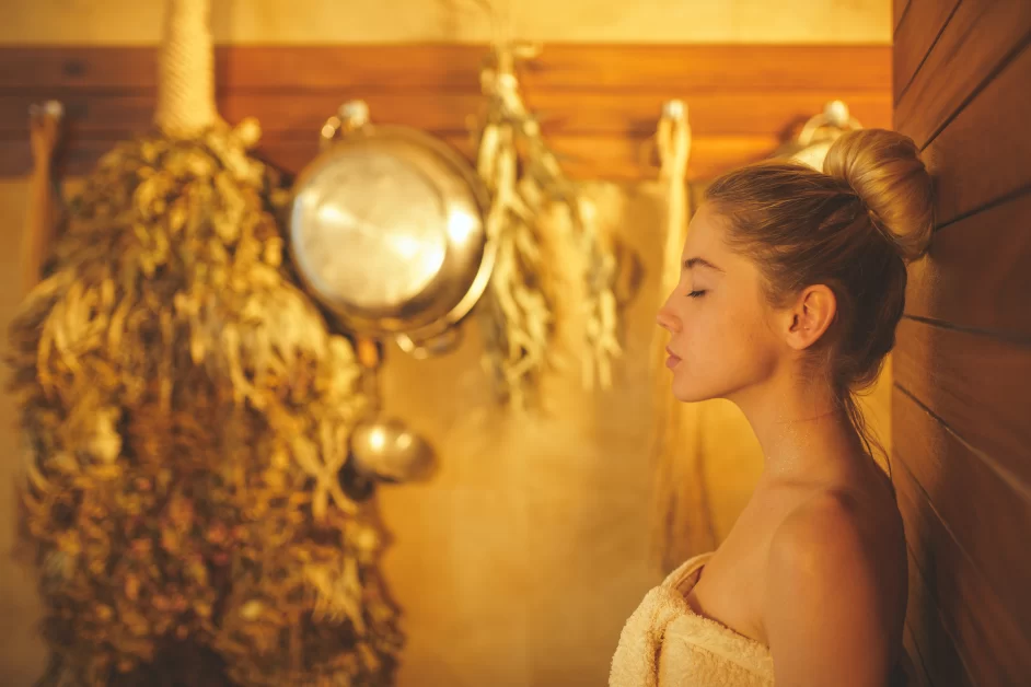 A young woman using infrared sauna.