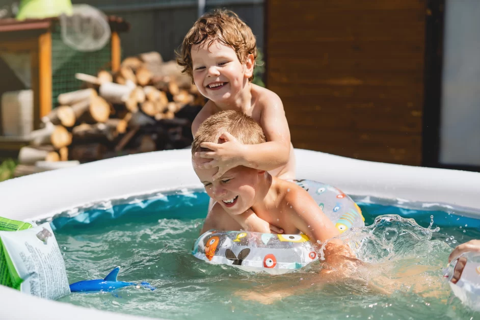 Children playing and having fun in an inflatable hot tub pool.