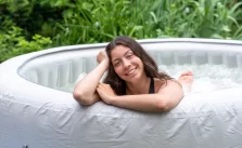 A young woman enjoing in a inflatable hot tub.