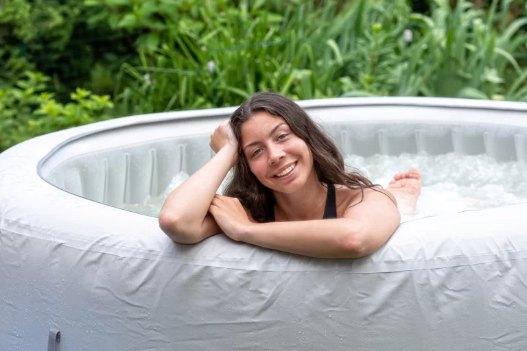 A young woman enjoing in a inflatable hot tub.