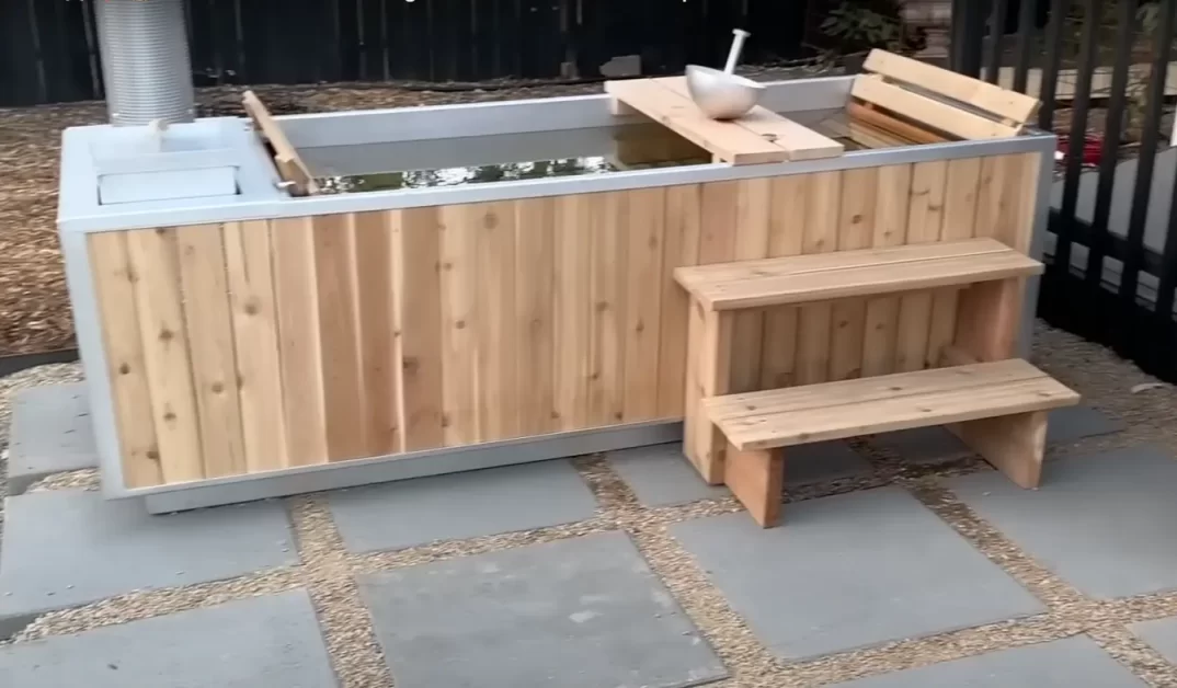 A ready to use wood fired hot tub placed on a concrete tiles.