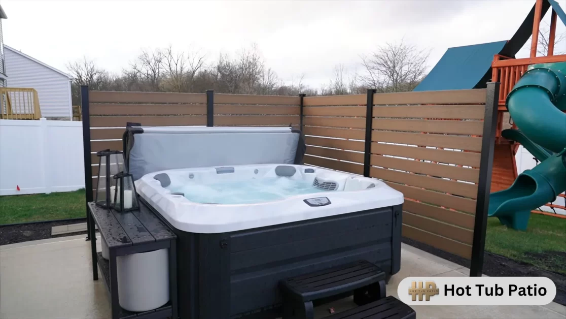 A hot tub with privacy wall in a outdoor space. 